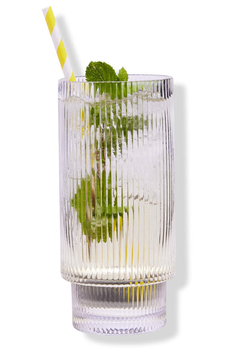 An elderflower cocktail with mint leaves, ice, and a yellow striped straw.